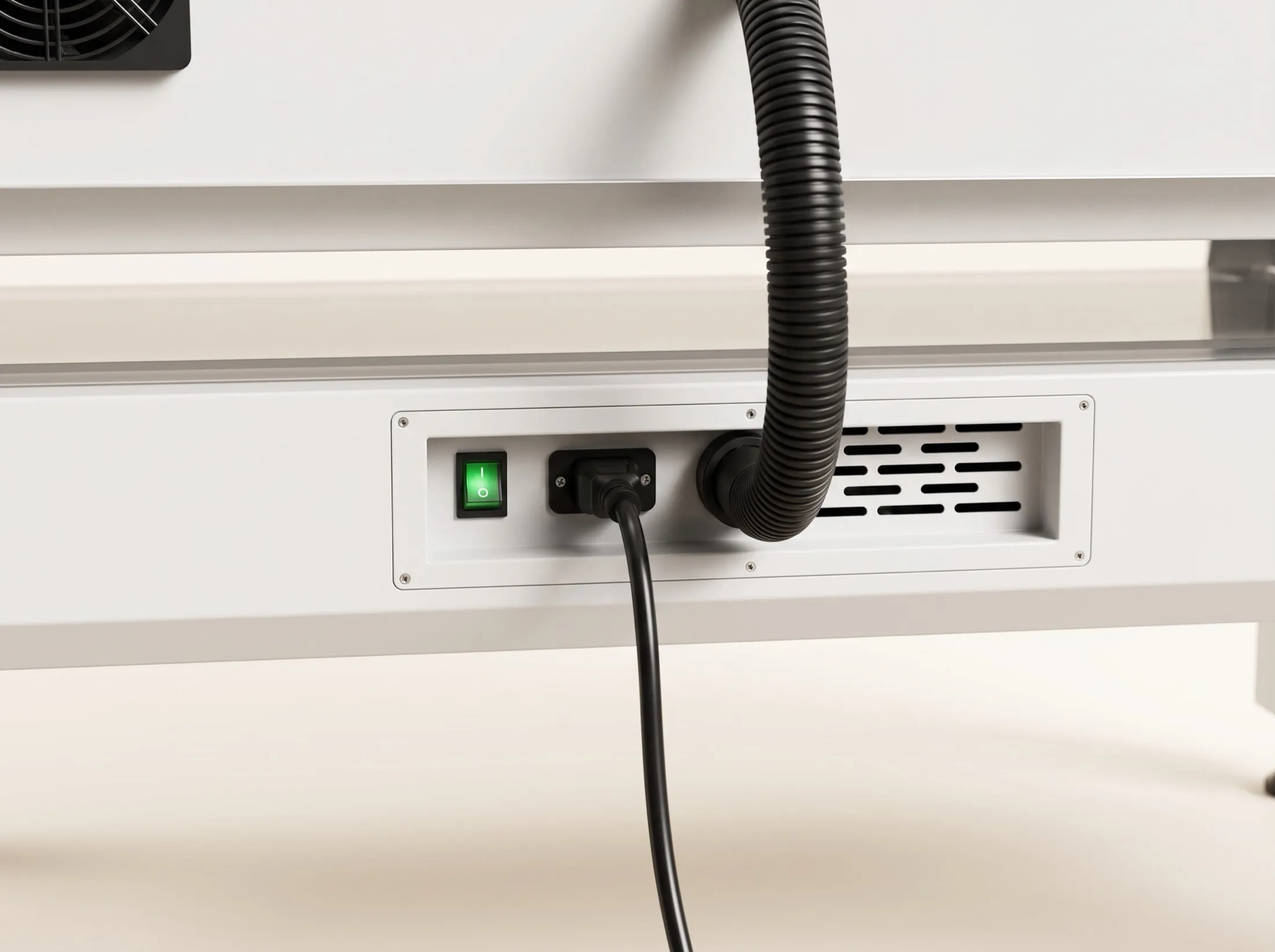 The power inlet and illuminated switch on the shell.