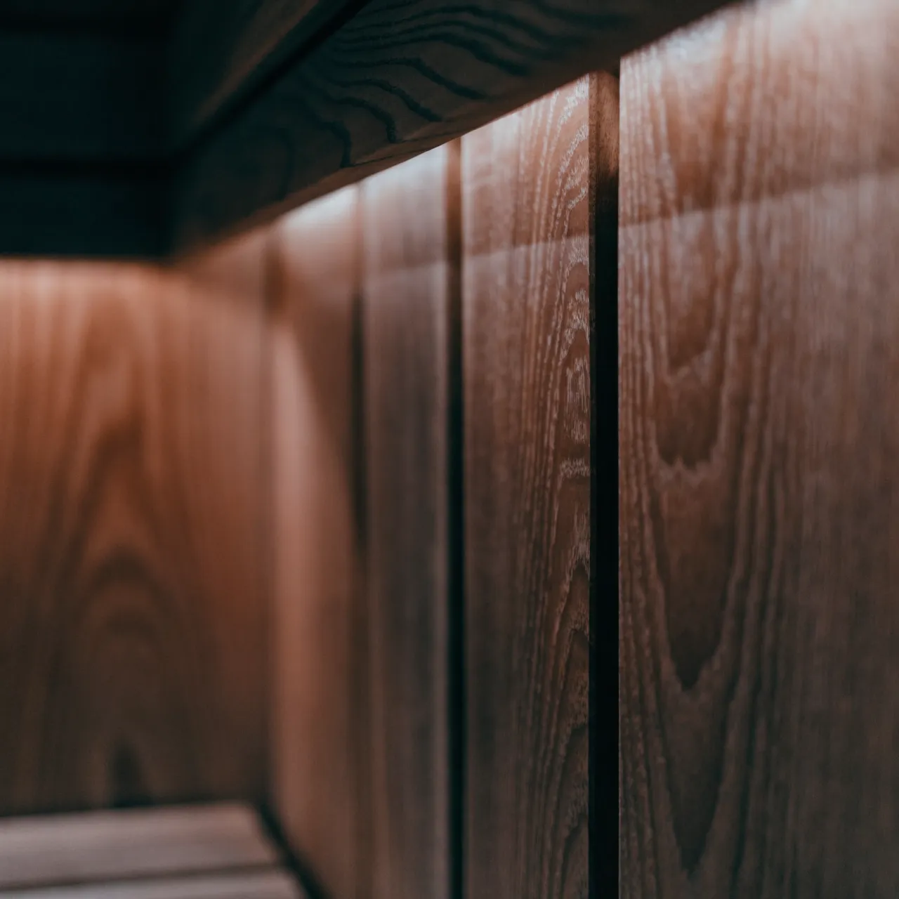 A cedar sauna wall lit by a concealed strip along the top