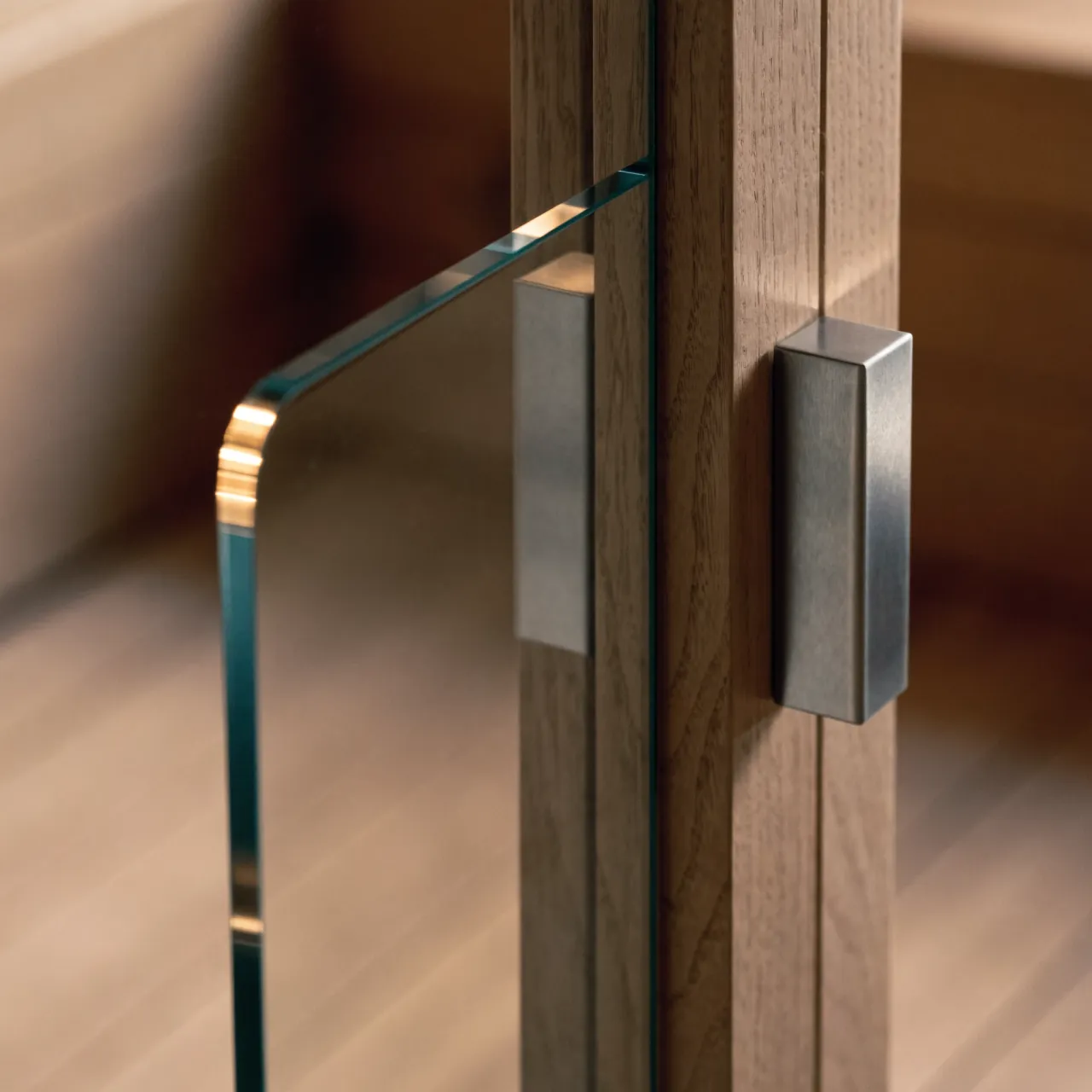 A frameless glass sauna door meeting its timber jamb