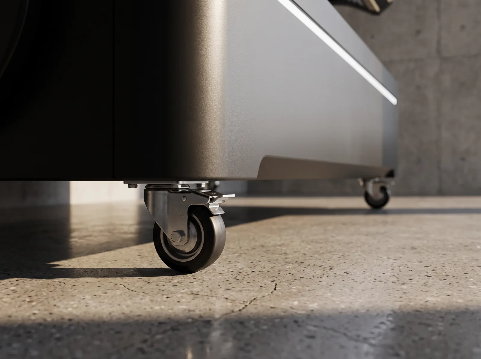 The braked swivel castor under the base, on a polished concrete floor.