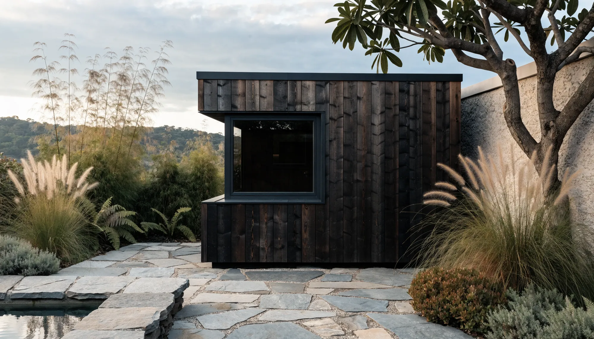 A charred timber sauna in a garden