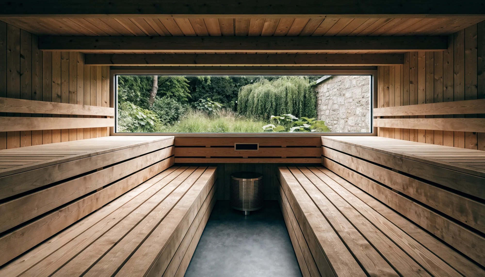 A sauna with a full-width courtyard window