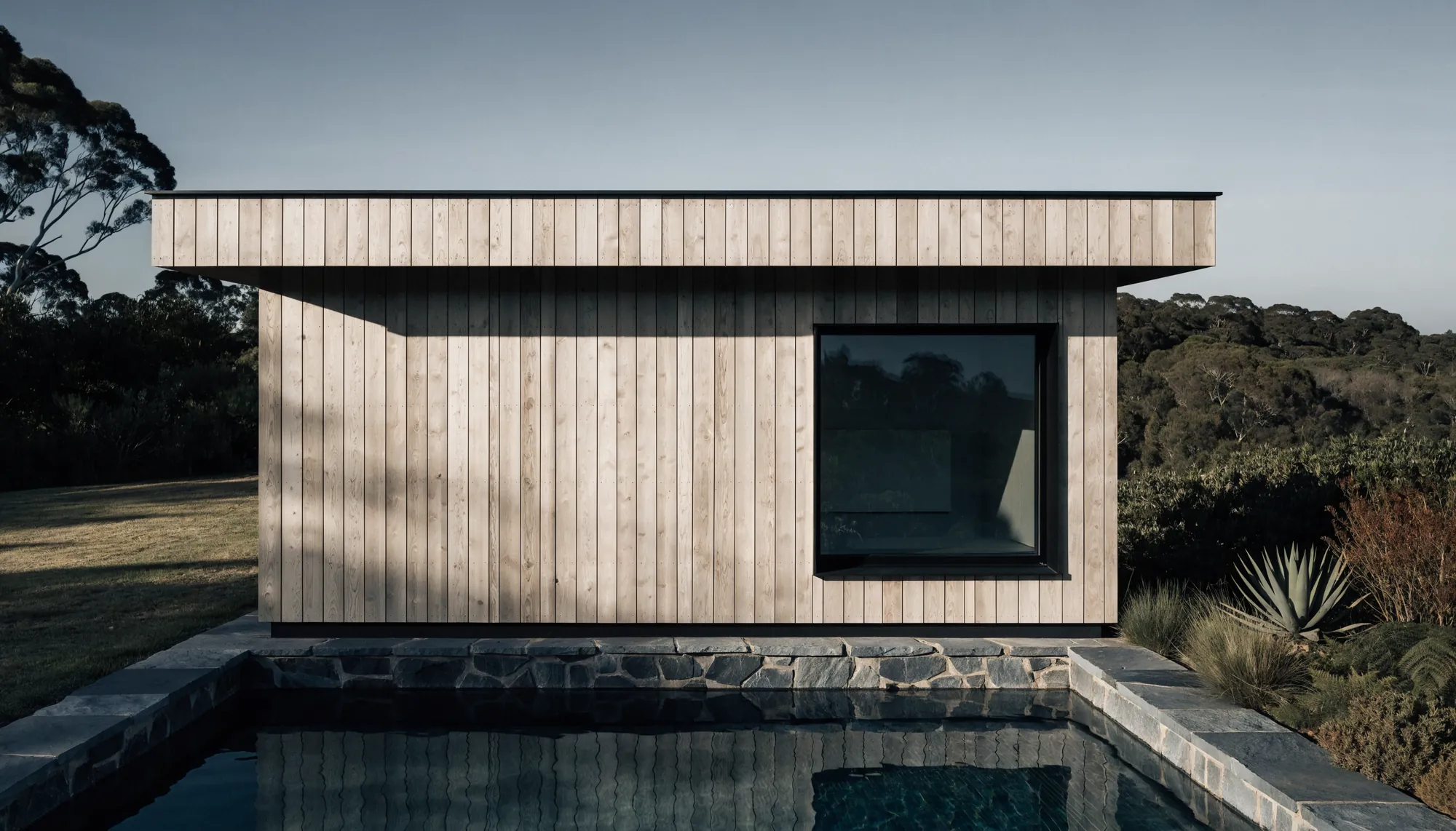 A sauna pavilion beside a lap pool