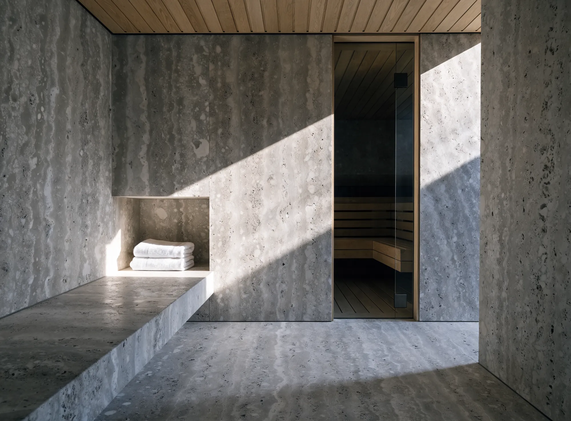 A travertine anteroom with a shaft of sunlight