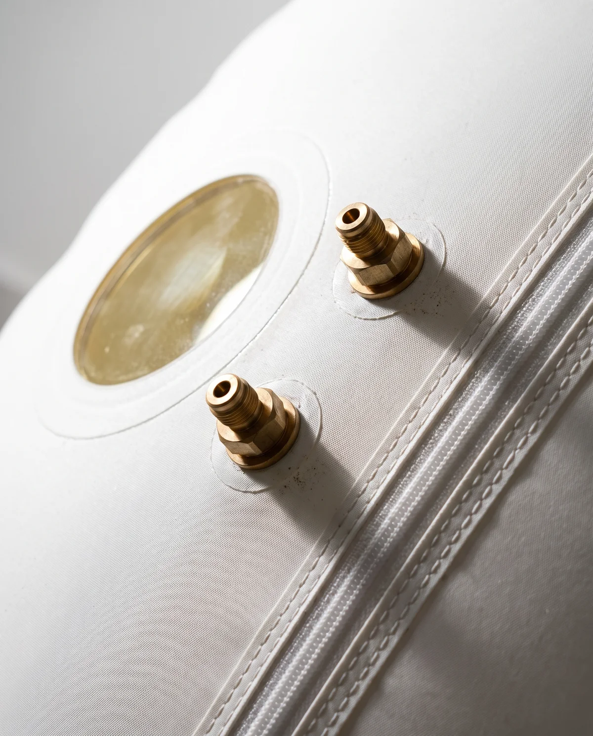 Close detail of the valve fittings, porthole window and zip on the white TPU cabin.